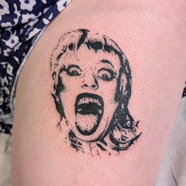Blackwork portrait tattoo of a screaming woman with a fringe